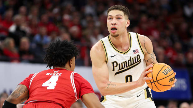 Mar 16, 2024; Minneapolis, MN, USA; Purdue Boilermakers forward Mason Gillis (0) controls the ball as Wisconsin Badgers guard Kamari McGee (4) defends during the first half at Target Center